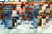 Team Member Checks An Outgoing Delivery In The Warehouse